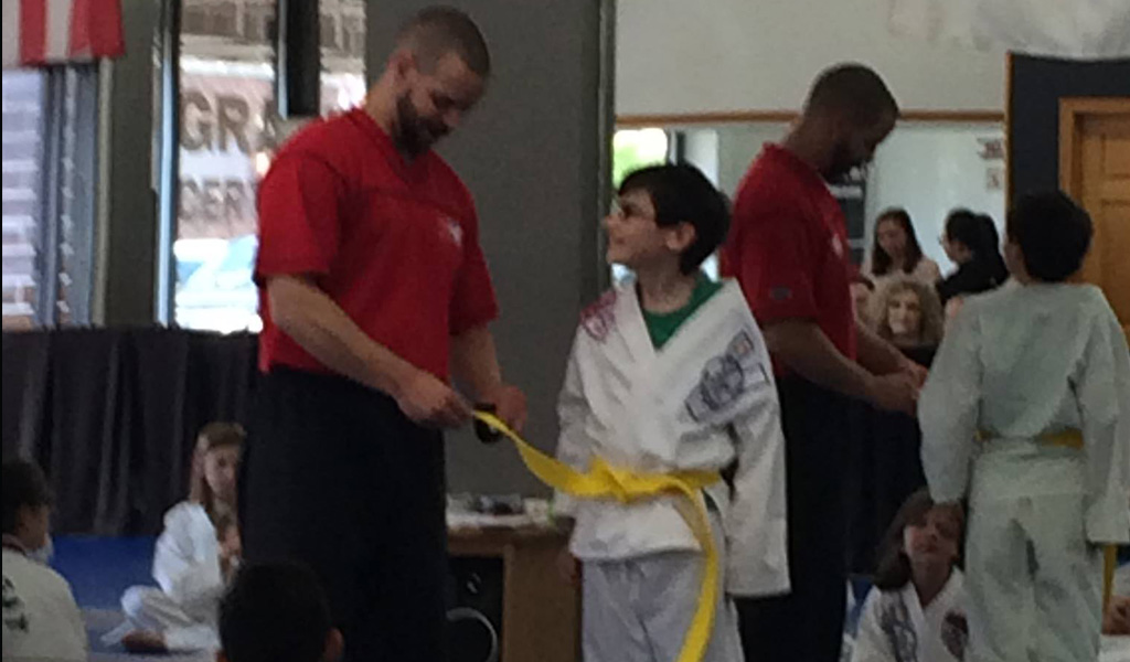 Billy receiving yellow belt in Karate